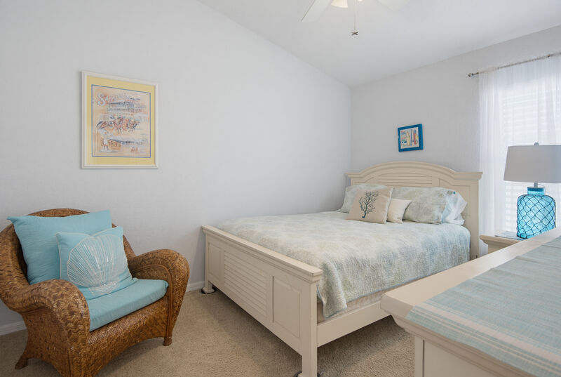 Cozy bedroom with a reading chair — the Lighthouse, New Smyrna Beach